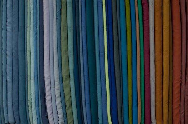 Fabrics lined up on a rack