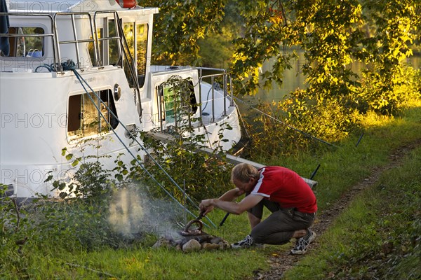 Man making a fire to grill for dinner