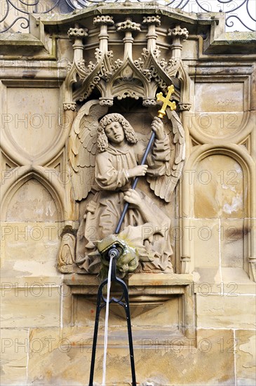 High-relief of St. Michael and the Dragon as a well figure on the Gothic Fischbrunnen fountain