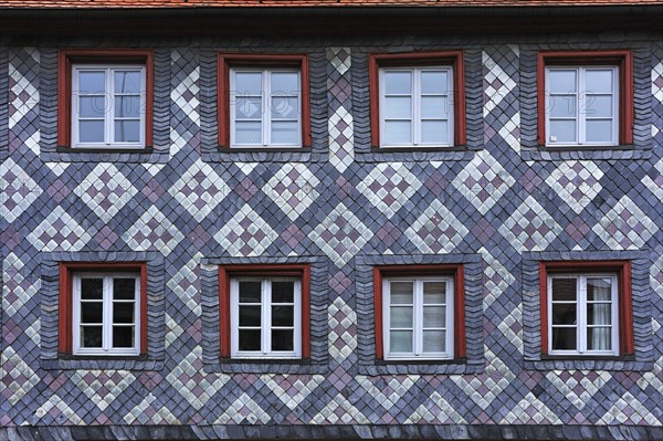 Old slate facade decorated with patterns