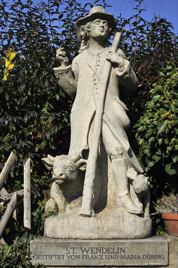 Sculpture of the shepherd St. Wendelin with a cow and pig