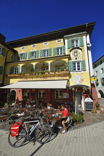 Cyclist having a break outside Cafe Cupido