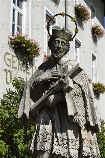 Statue of a bridge saint in front parish town hall