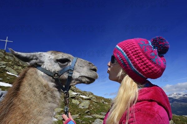 Young woman with a llama