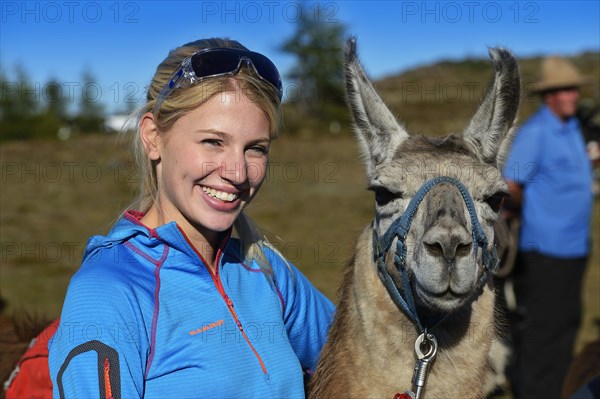 Tourist during a llama tour to the summit of Boeses Weibele Mountain in the Defregger Group