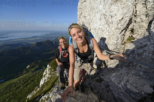 Hikers climbing to the summit of Kampenwand Mountain