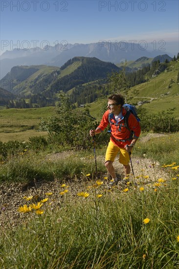 Hiker ascending Geigelstein Mountain