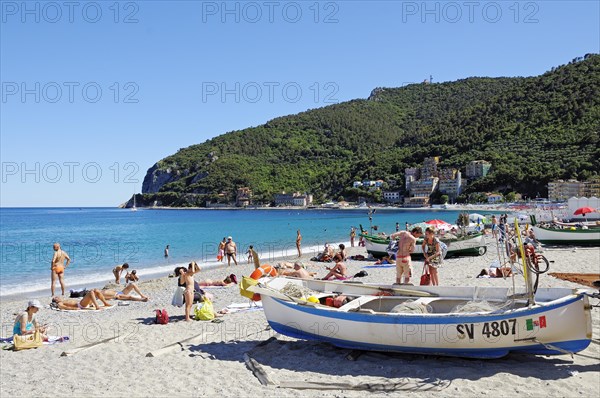 Fishing boats and bathers on the beach of Noli