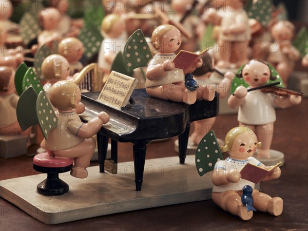 Handmade wooden angels playing musical instruments as a table decoration from the Erzgebirge or Ore Mountains