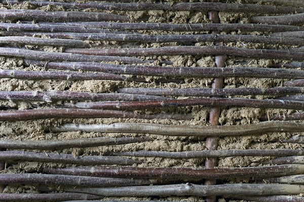 Wall construction made of woven hazel rods lined with clay