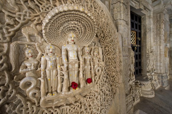 Tirthankar Parshvanat in the medallion protected by the thousand-headed serpent God Dharanendra against a powerful storm