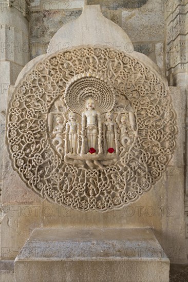Tirthankar Parshvanat in the medallion protected by the thousand-headed serpent God Dharanendra against a powerful storm