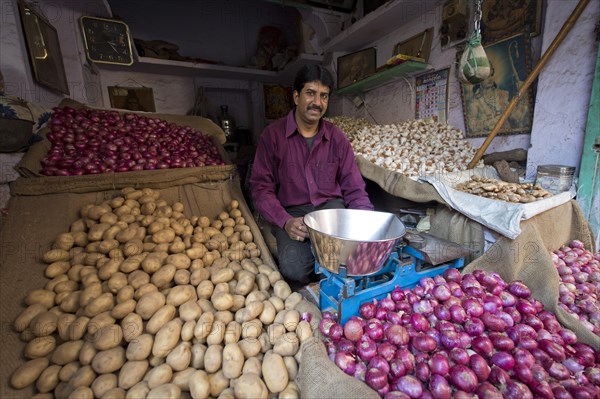 Potato and onion trader at his market stand