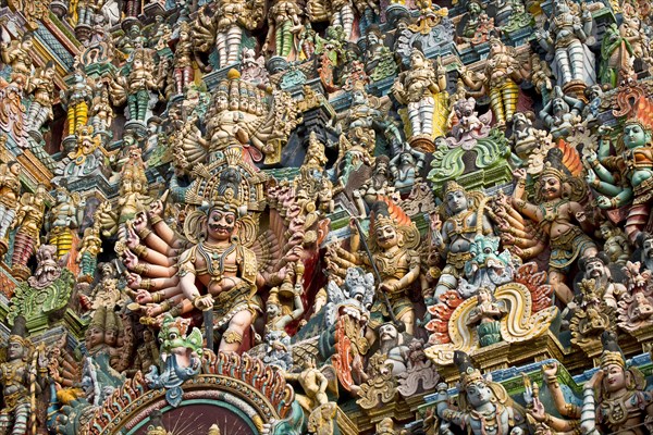 Colourful statues of gods and demons on the Gopuram or Gopura gate tower