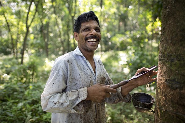 Smiling worker on a natural rubber plantation