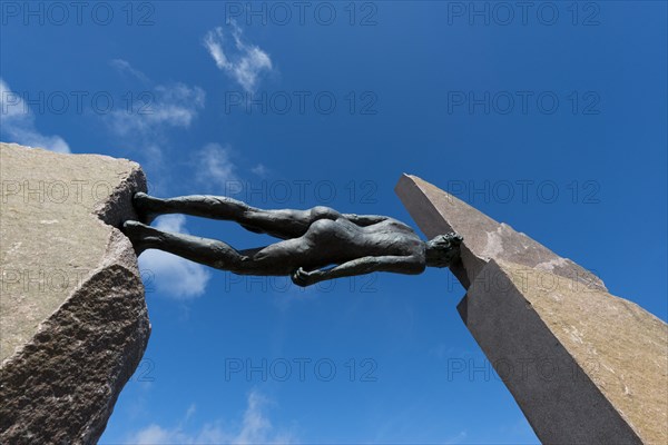 Bronze sculpture of a woman between two stones