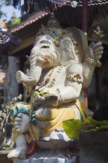 Stone figure of Ganesha with an umbrella