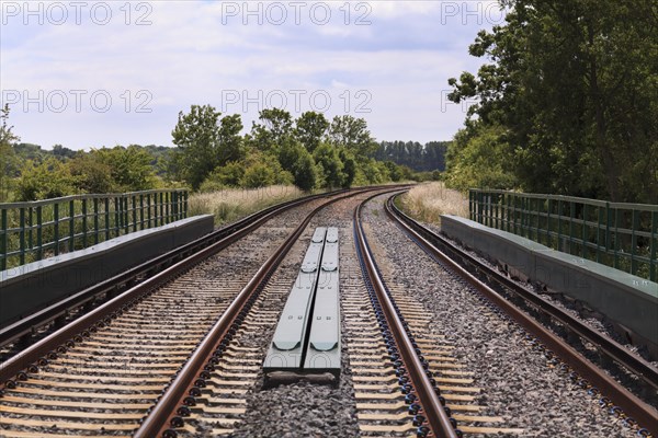 Twin track railway line disappearing around a bend