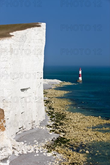 Lighthouse and white limestone cliffs at Beachy Head