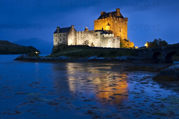 Eilean Donan Castle illuminated at dusk