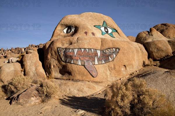 Face painted on a rock