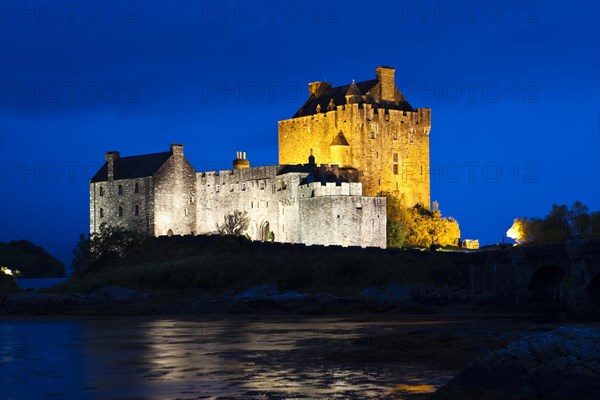 Eilean Donan Castle illuminated at dusk