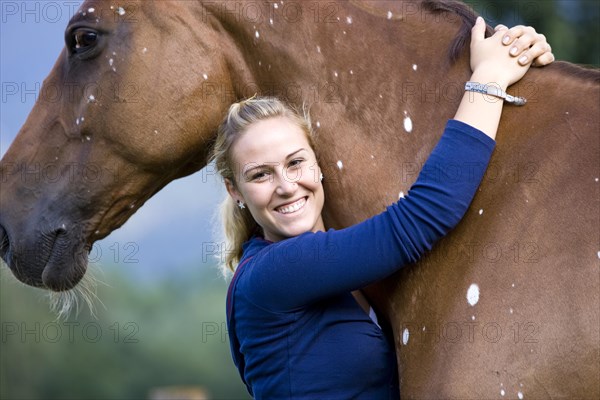 Young woman hugging a Hanoverian