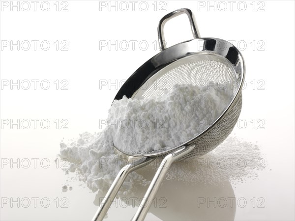 Powdered sugar in a sieve