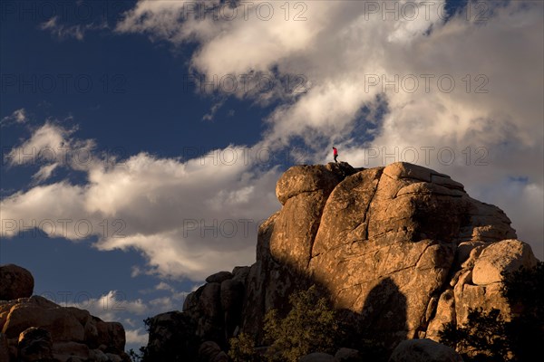Climber on top of a rock