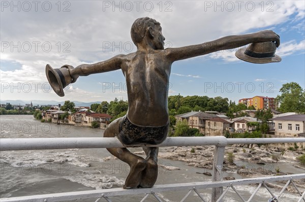 Sculpture of a boy holding two hats