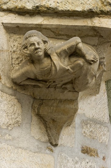 Stone house sign with a figure pointing their buttocks towards the Town Hall