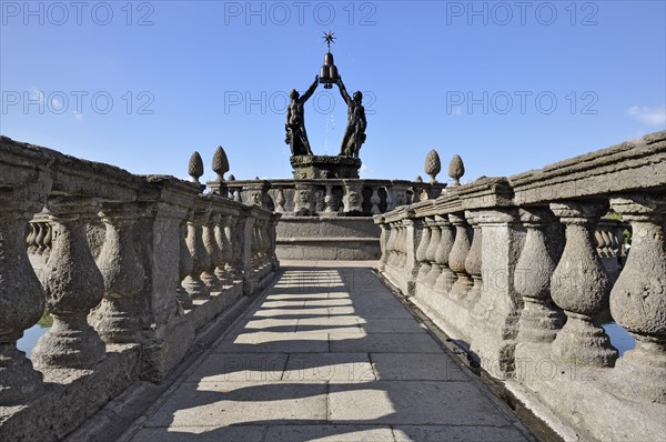 Bronze figures of young men holding heraldic symbols of the Montalto