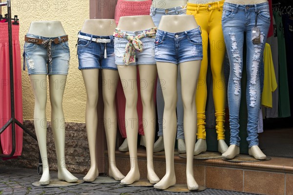 Legs of mannequins with jeans and hot pants