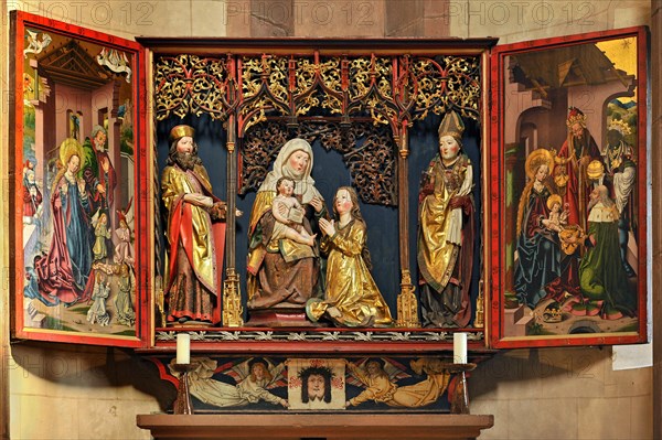 Carved altar dedicated to St Anne with the Anna selbdritt group between two saints