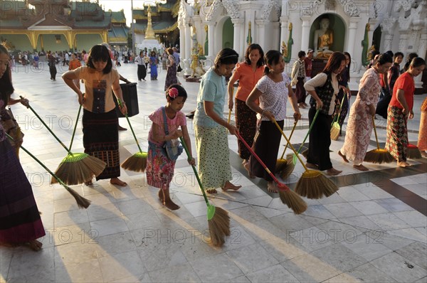 Women sweeping the floor as a ritual action