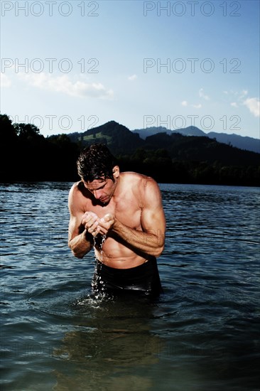 Man standing in a lake in Sonthofen