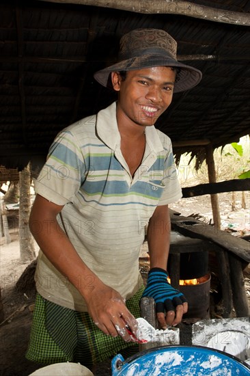 Young man during the production of fresh rice noodles