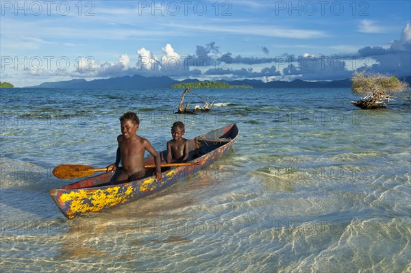 Boys in a canoe in the Marovo Lagoon