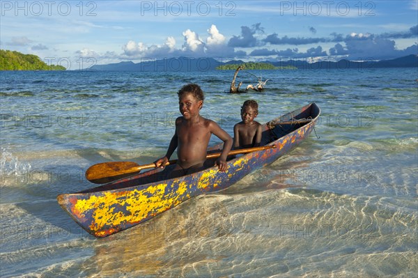 Boys in a canoe in the Marovo Lagoon