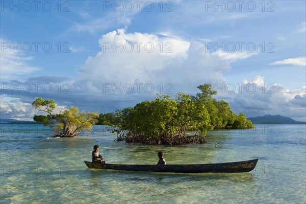 Boys in a canoe in the Marovo Lagoon