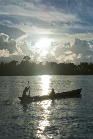 Boys in a canoe in the Marovo Lagoon