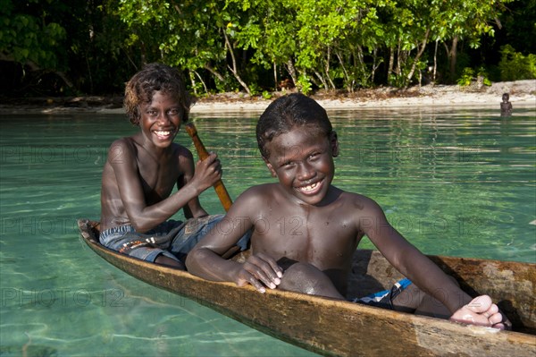 Local boys in a canoe in the Marovo Lagoon