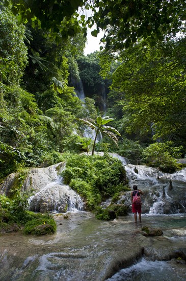 Woman looking at the Mele-Maat Cascades