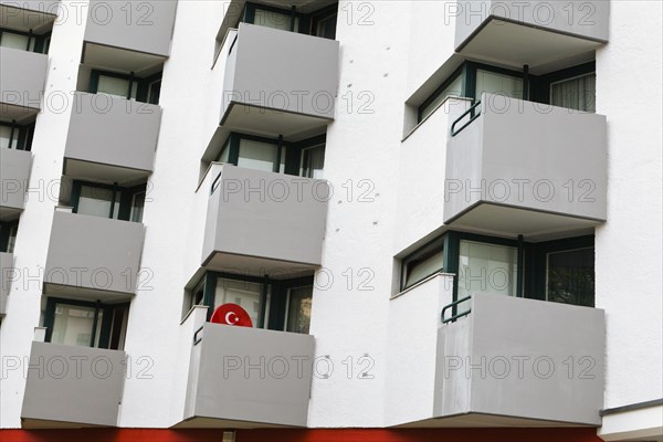 Satellite dish with the symbol of the Turkish flag on the balcony of a residential building