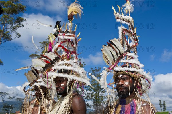 Members of a tribe in colourfully decorated costumes with face paint at the traditional sing-sing gathering