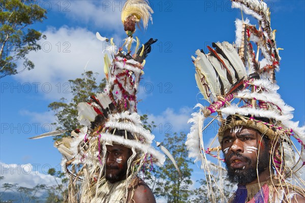 Members of a tribe in colourfully decorated costumes with face paint at the traditional sing-sing gathering