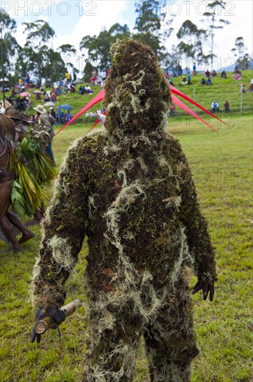 Man covered in moss at the traditional sing-sing gathering