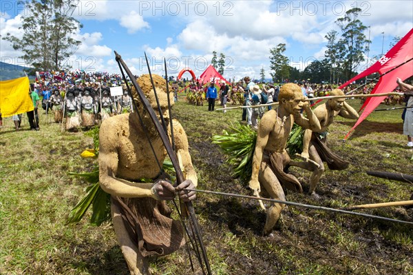 Members of a tribe in colourfully decorated costumes with face and body paint at the traditional sing-sing gathering