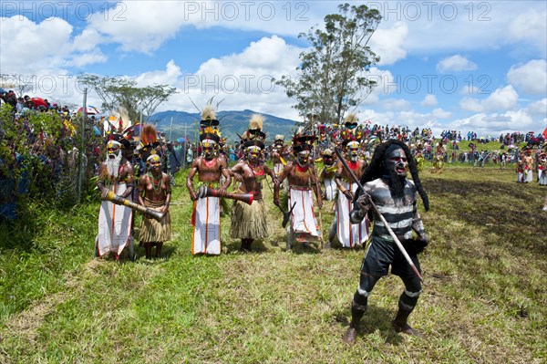 Members of a tribe in colourfully decorated costumes with face and body paint at the traditional sing-sing gathering