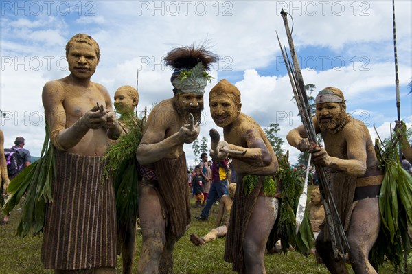 Members of a tribe in colourfully decorated costumes with face and body paint at the traditional sing-sing gathering